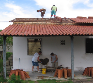 men working on roof of office building
