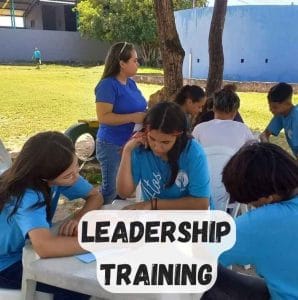 cbc students outside with teacher doing leadership activity