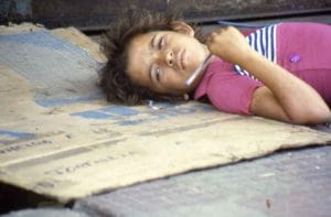 boy laying on sidewalk