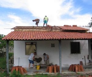 Med working on building/roofing