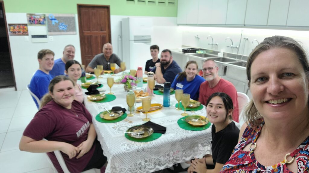 Group of people sitting around a dinner table.