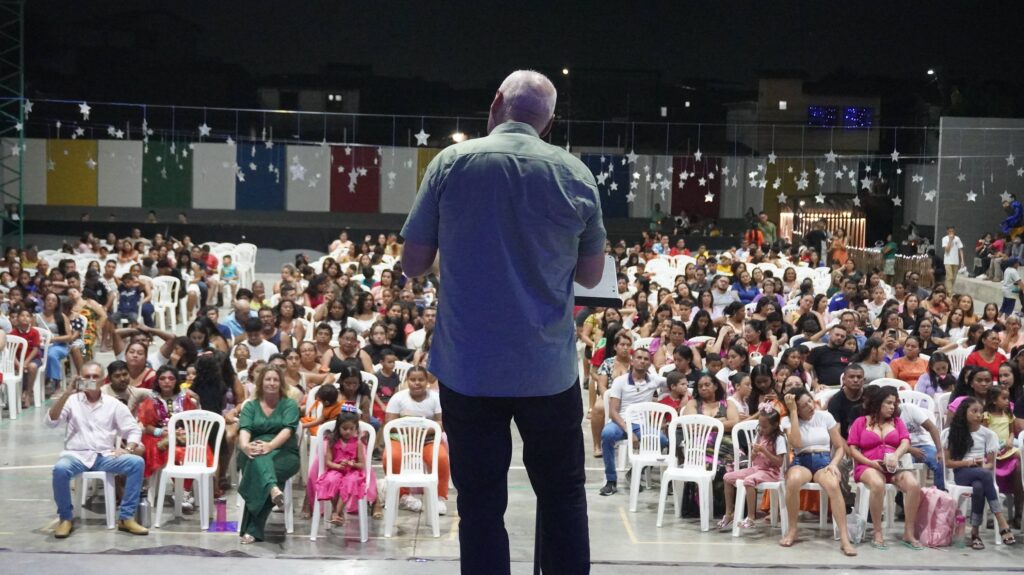 Man speaking to a crowd.